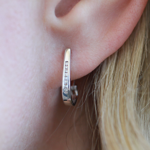 10kt White Gold 0.07cttw Diamond Oval Channel Hoop Earring